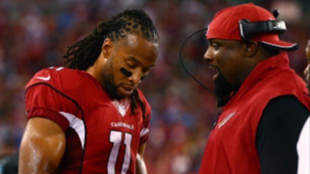 Arizona Cardinals wide receiver Larry Fitzgerald (11) talks with defensive line coach Brentson Buckner against the San Diego Chargers at University of Phoenix Stadium.